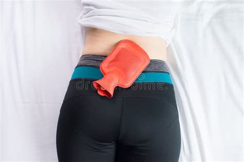 Female Suffering From Abdominal Pain Period Cramps Woman Using Hot Water Red Bag Or Bottle On