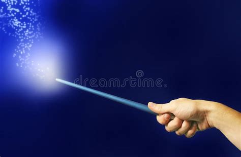 Magic Wand A Hand Is Holding A Magic Wand That Emits Light And