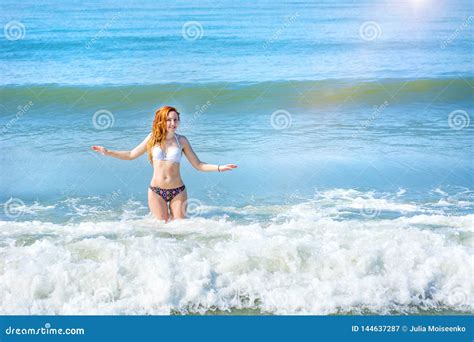 Beautiful Girl In Bikini Posing On A Deserted Beach White Sand