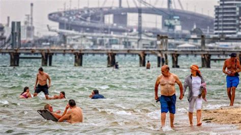 Seeking relief from the hot weather at Port Melbourne beach in January ...