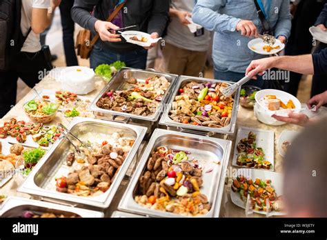 Hand Of People Take Buffet Food In Hotel Party Food And Drink Stock