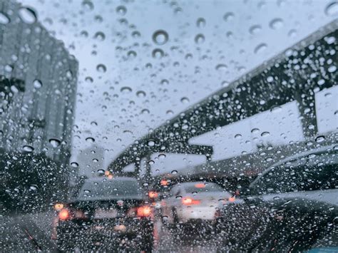 Raindrops Run Down On Car Windshield From Inside View Traffic Jam