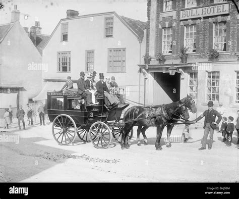 Horse Drawn Bus With Passengers Outside The Bull Hotel Burford High