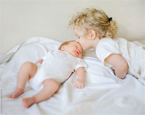 Girl Kissing Newborn Baby By Stocksy Contributor Duet Postscriptum