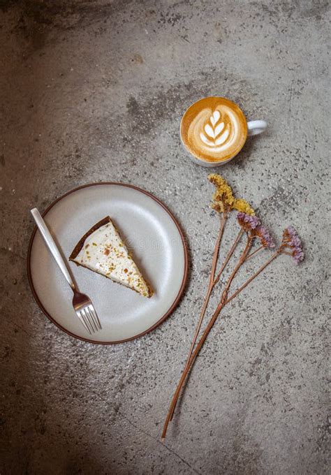 Overhead Shot Of Cheesecake On The Plate And Cappuccino Stock Photo