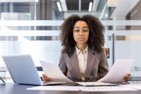 professional black woman business suit holding paper documents
