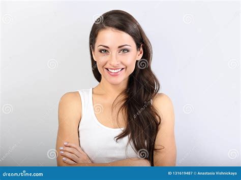 Front View Of Beautiful Woman With Nude Makeup And Healthy Shine Skin Looking With Folded Arms