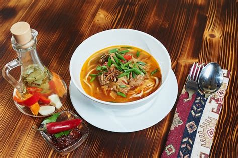 Premium Photo Oriental Lagman Uzbek Soup On A Wooden Table