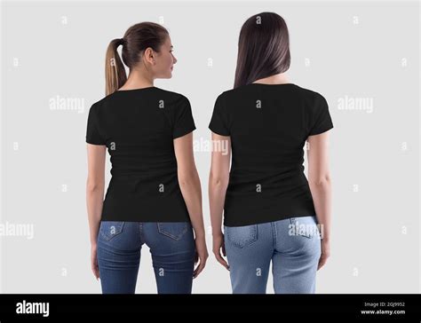 Mockup of a black paired t-shirt on two girls in jeans, blank clothes for logo, brand, print ...