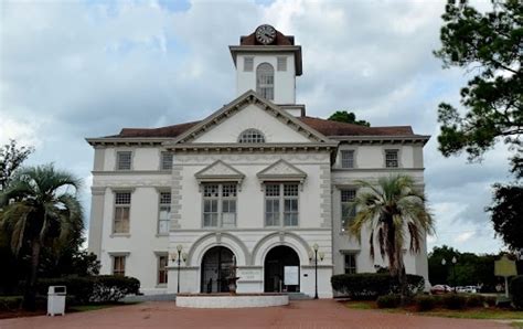 a large white building with a clock tower