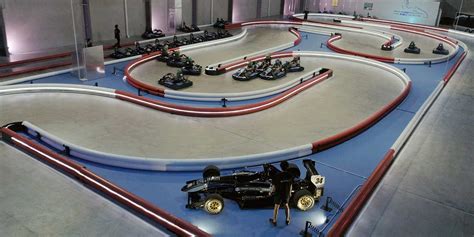 several go karts are lined up in the middle of an indoor race track area