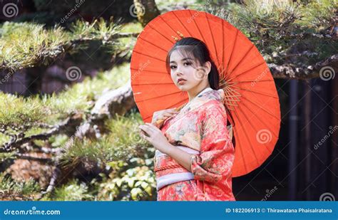 Asian Woman Tourists Japanese Girl Wearing A Kimono Holding A Red