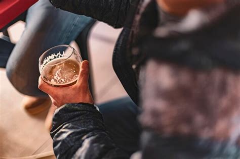 Premium Photo Closeup Of Hand Holding A Glass Of Beer