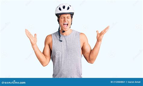 Young Handsome Man Wearing Bike Helmet Celebrating Mad And Crazy For