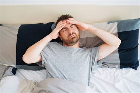 Restless Man Waking Up Early With Headache After Troubled Night Stock