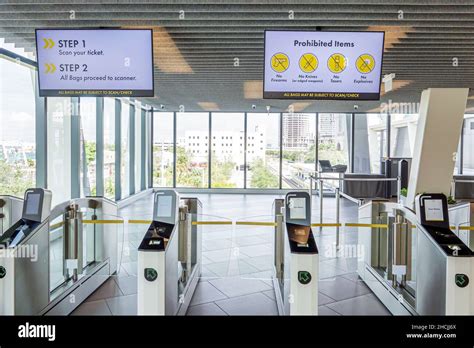 Station inside interior gates turnstiles overhead sign signs ...