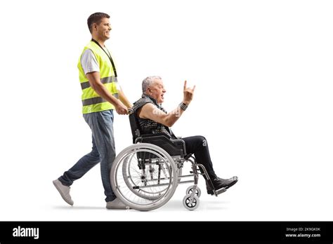 Full Length Profile Shot Of A Community Worker Pushing A Punk In A