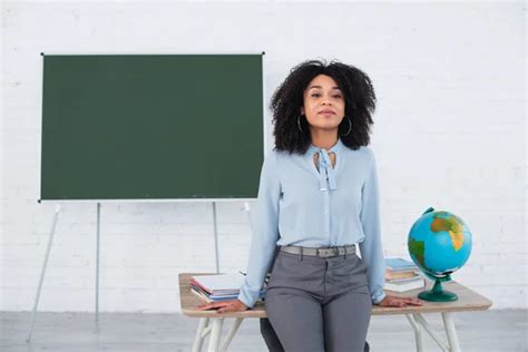 Happy African American Teacher Crossed Arms Standing Working Table