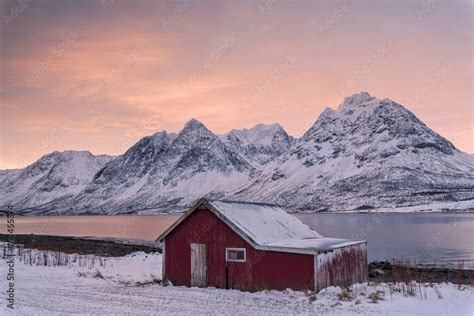 Pink Clouds At Dawn On The Wooden Hut Surrounded By Frozen Sea And