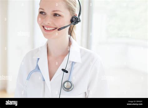 Doctor using a headset Stock Photo - Alamy