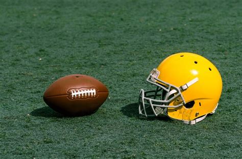 Premium Photo Stadium Grass With Football Helmet And Ball On It