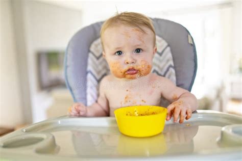 A Little Baby Eating Her Dinner And Making A Mess Stock Photo Image