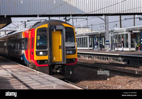 Class 158 Express Sprinter Passenger Train In East Midlands Trains Livery Waiting At A Railway