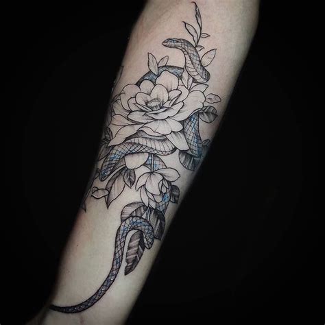 A Snake And Flowers Tattoo On The Arm