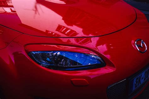 Vibrant Red Car Reflecting Strasbourg ArchitectureFree Stock Photo