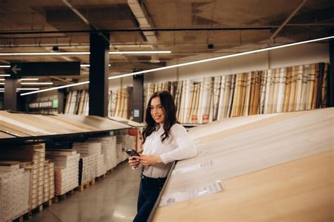 Premium Photo Happy Brunette Female Interior Designer Choosing Flooring Tile Color Texture