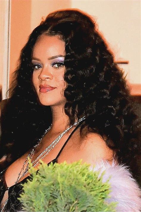 A Woman With Long Curly Hair And Blue Eyeshades Is Posing For The Camera