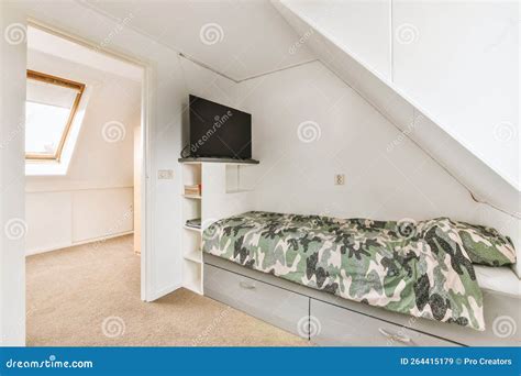 A Small Bedroom with a Bed and a Tv on Stock Image - Image of domestic, bedroom: 264415179