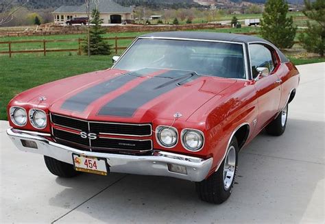 A Red And Black Car Is Parked In The Driveway