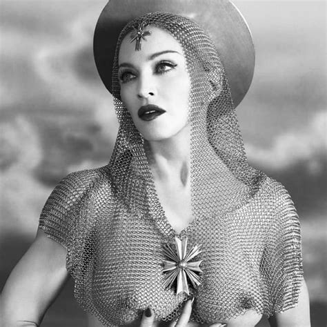 A Woman Wearing A Hat And Dress With An Unusual Design On Her Chest