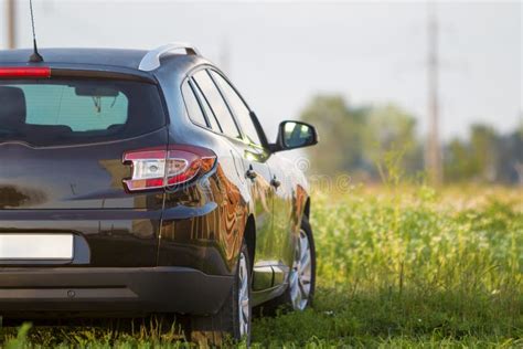 Back Of New Black SUV Car Parking On The Asphalt Road Stock Photo