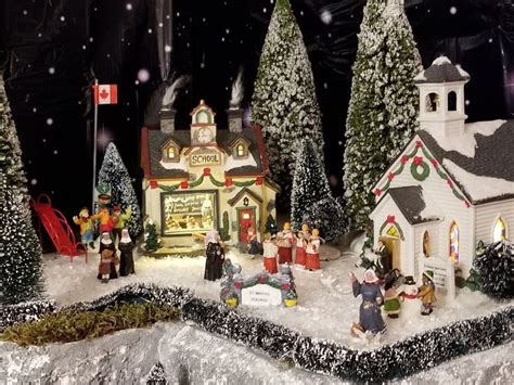 a christmas village with lots of trees and people