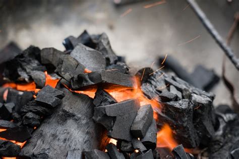 Premium Photo | Burning charcoal close-up. Coal in fire and smoke.