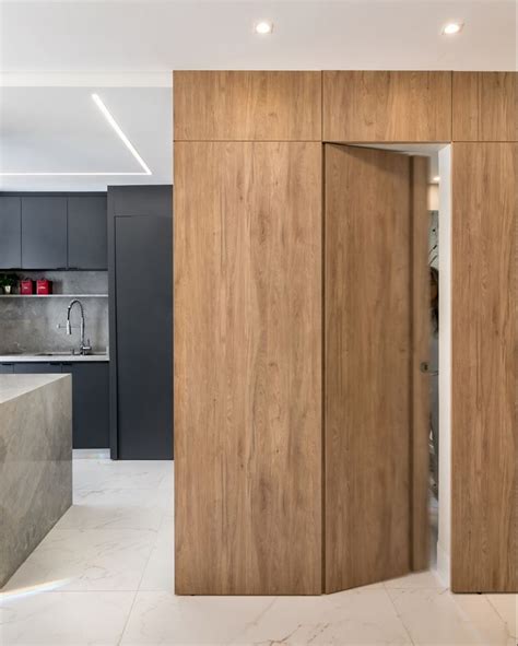 An Open Door Leading To A Kitchen With Marble Counter Tops And Cabinets