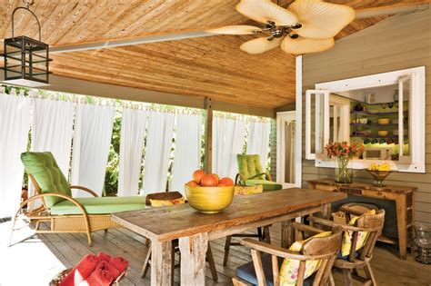 A Wooden Table Sitting On Top Of A Wooden Floor Next To A Green Chair