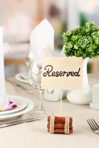 Premium Photo Reserved Sign On Restaurant Table With Empty Dishes And