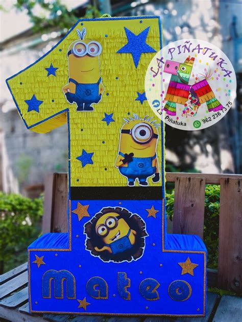 A Blue And Yellow Birthday Cake With A Despicable Minion Shirt On It