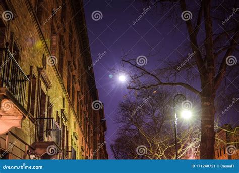 Nighttime Shot Of The Moon A Street Lamp And Building Facade In