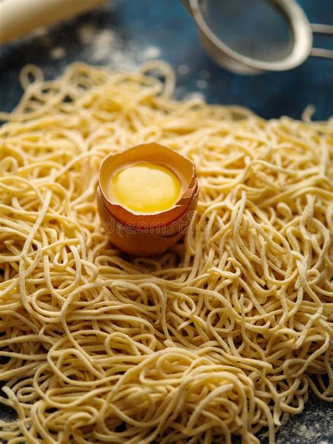 Dried Egg Noodles Raw Fresh Spaghetti On Blue Wooden Background Stock