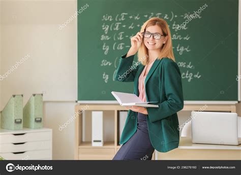 Beautiful female teacher in classroom — Stock Photo © serezniy #296276160