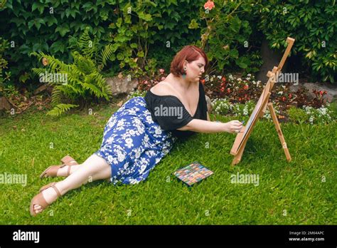 Red Haired Argentinian Caucasian Latina Woman Plus Size Model Lying On The Grass In The