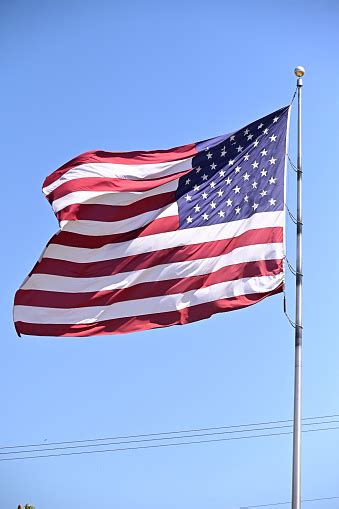 American Flag Flying High Stock Photo - Download Image Now - American ...