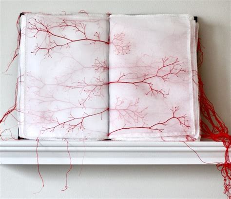 Knotted Systems Of Red Thread Dangle From Fabric Books And Letters By