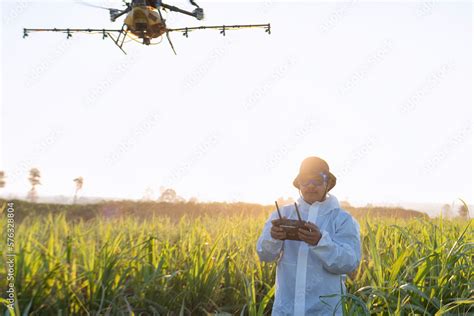 farmer navigating drone at rice field using high technology increasing ...