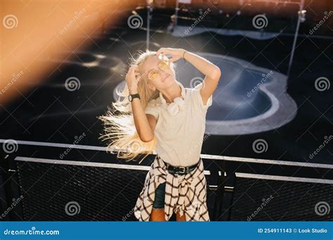 Romantic Woman Posing In Skate Park With Long Blonde Hair Waving Outdoor Portrait Of