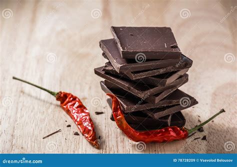 Dark Chocolate Bars Stack with Chili Peppers on Wooden Table. Stock ...